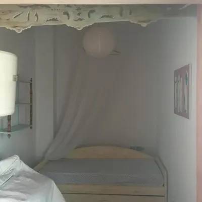 a bed with a canopy in a bedroom at La casita de la dormilona in Algimia de Almonacid