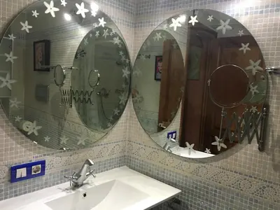 two mirrors above a sink in a bathroom at La casita de la dormilona in Algimia de Almonacid