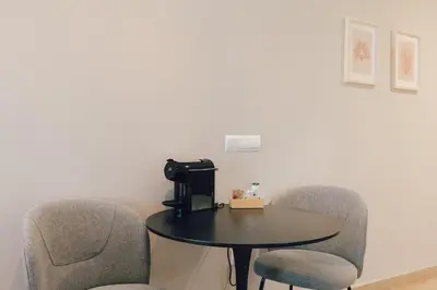 a room with two chairs and a table with a tv at Palau Suites & Apartments in Valencia