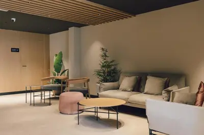 a living room with a couch and a table and chairs at Palau Suites & Apartments in Valencia