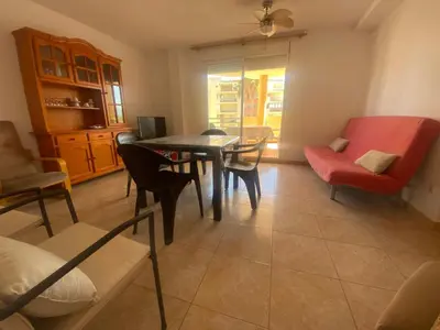 a living room with a table and chairs at Bitacora II solo Familias Serviplaya in Casas Las Basas