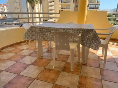 a table and chairs sitting on a balcony at Bitacora II solo Familias Serviplaya in Casas Las Basas
