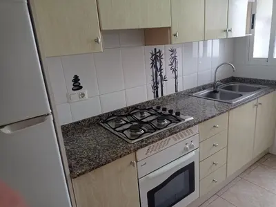a kitchen with a stove top oven next to a sink at Bitacora II solo Familias Serviplaya in Casas Las Basas