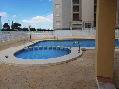 a large swimming pool in the middle of a building at Bitacora II solo Familias Serviplaya in Casas Las Basas