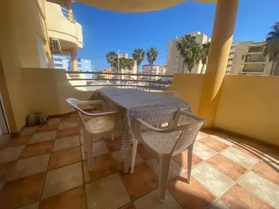 a table and chairs on a balcony with a view at Bitacora II solo Familias Serviplaya in Casas Las Basas
