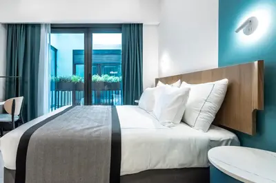 a bedroom with a large bed and a balcony at PAMPHYLIA HOTEL in Valencia