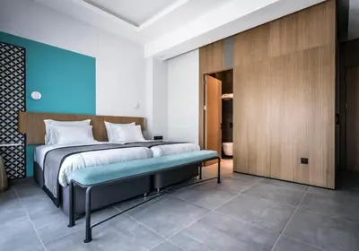 a bedroom with a large bed and a bench at PAMPHYLIA HOTEL in Valencia