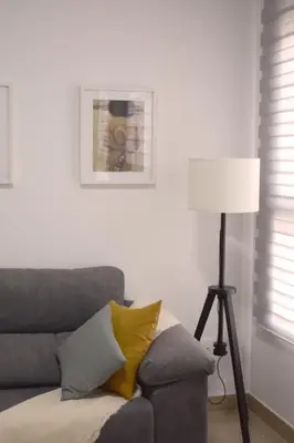 a living room with a couch and a lamp at Natura Apartments in Chelva