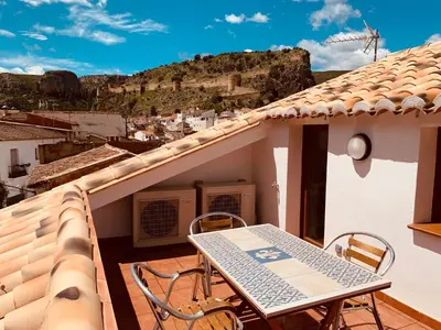 a balcony with a table and chairs on a house at Casa del Herrero in Chulilla