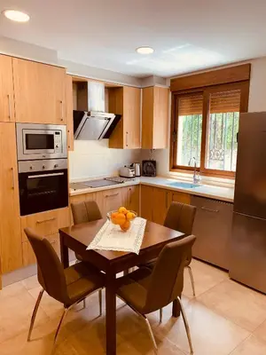 a kitchen with a table and chairs in a kitchen at Casa del Herrero in Chulilla