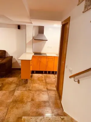 a kitchen with orange cabinets and a counter top at Casa del Herrero in Chulilla