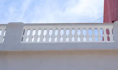 a white railing on top of a building at Balaustrada Apartments in Burjasot