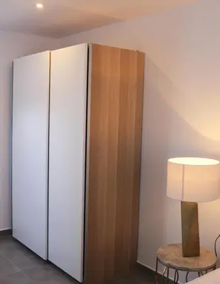 a large white cabinet in a room with a lamp at Balaustrada Apartments in Burjasot