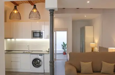 a kitchen and living room with a washer and dryer at Balaustrada Apartments in Burjasot