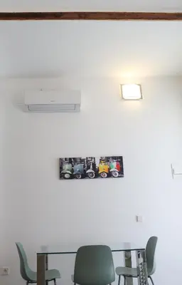 a table and chairs in a room with a picture on the wall at Balaustrada Apartments in Burjasot