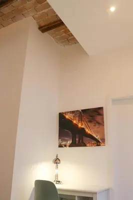 a painting of a bridge hanging on a wall at Balaustrada Apartments in Burjasot