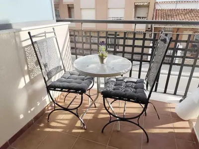 a small table and two chairs on a balcony at Caudiel entre Sierras in Caudiel