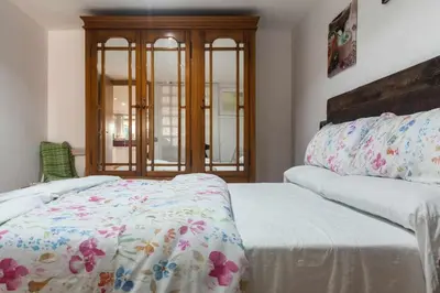 a bedroom with a bed with a floral bedspread at Villa del Mar . in Puebla de Farnals