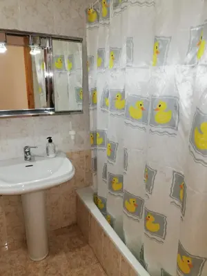 a bathroom with a sink and a shower curtain with a rubber duck at Parquemar I Solo Familias Serviplaya in Casas Las Basas