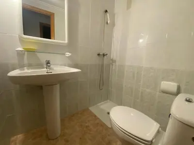 a white bathroom with a sink and a toilet at Parquemar I Solo Familias Serviplaya in Casas Las Basas