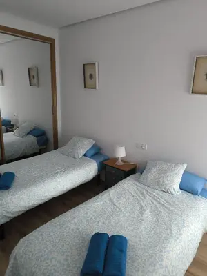 a bedroom with two beds and a mirror at Bet Apartments - Sunrise Beach Apartments in Valencia