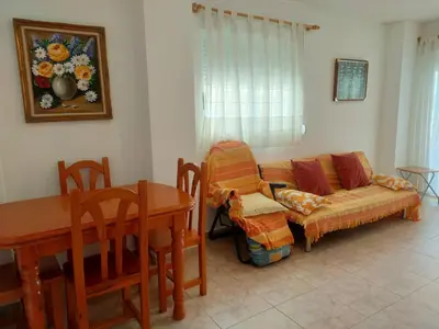 a living room with a couch and a table at Parquemar III-IV Solo Familias!!! Serviplaya in Casas Las Basas