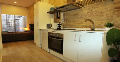 a kitchen with a sink and a stove top oven at Loft independiente con Piscina compartida en Centro de Valencia in Valencia
