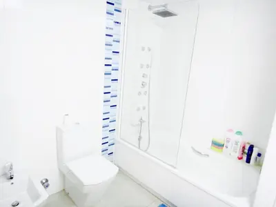 a white bathroom with a shower and a toilet at Patacona Beach Power!! in Valencia