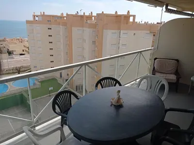 a living room with a window and a chair at Mar Azul Solo Familias Serviplaya in Casas Las Basas