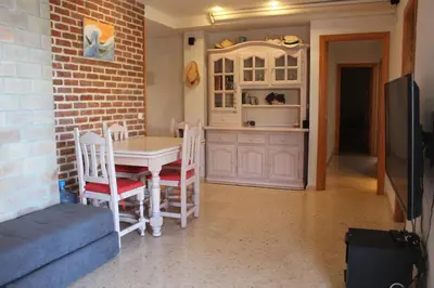 a kitchen with a table and chairs in a room at Los Naranjos Solo Familias in Casas Las Basas