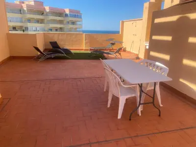 a patio with a table and chairs on a balcony at Los Naranjos Solo Familias in Casas Las Basas