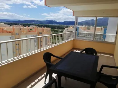 a table and chairs on a balcony with a view at Los Naranjos Solo Familias in Casas Las Basas