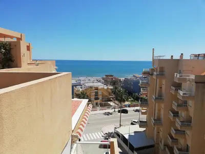 a view of the ocean from a building at Los Naranjos Solo Familias in Casas Las Basas
