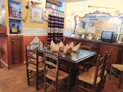 a dining room with a table and a mirror at A la Sombra de la Torre in Serra