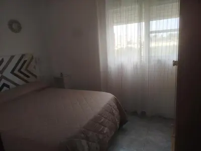 a bedroom with a bed and a large window at Apartamento estudio en playa Puig in Valencia