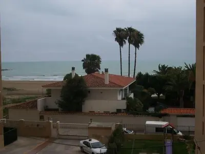 a white car parked in front of a house at Apartamento estudio en playa Puig in Valencia