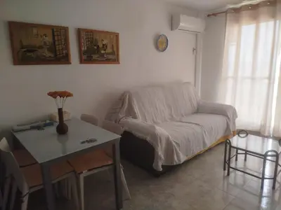 a living room with a couch and a table at Apartamento estudio en playa Puig in Valencia