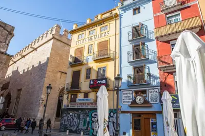 a yellow building with umbrellas in front of it at Finca Reloj in Valencia