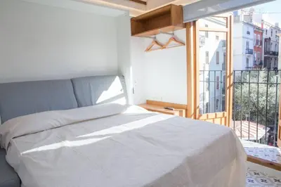 a bedroom with a bed and a large window at Finca Reloj in Valencia