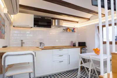 a kitchen with white cabinets and a sink at Finca Reloj in Valencia