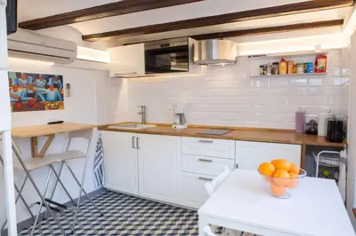 a kitchen with a bowl of oranges on a table at Finca Reloj in Valencia