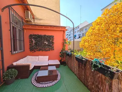 a balcony with a table and chairs on a building at Portrait Boutique Guesthouse in Valencia