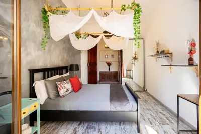 a bedroom with a bed with a canopy at Portrait Boutique Guesthouse in Valencia