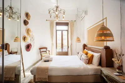 a bedroom with a bed and a mirror at Portrait Boutique Guesthouse in Valencia