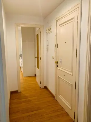 an empty hallway with a white door and wooden floors at Ayuntamiento Silence in Valencia