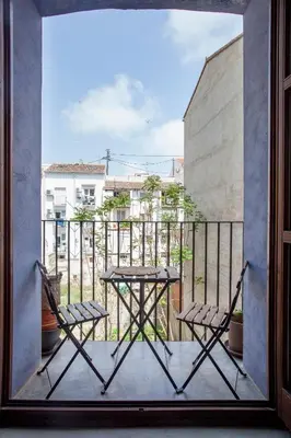 a view of a balcony with two chairs and a table at Loft Mercado Mossen Sorell in Valencia