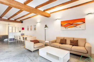 a living room with a couch and a table at Loft Mercado Mossen Sorell in Valencia