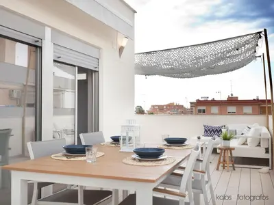 a dining room with a table and chairs at Increible ático con vistas al Mediterraneo by Hometels in Puerto de Sagunto