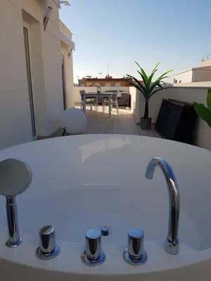 a kitchen sink with a faucet on a balcony at Increible ático con vistas al Mediterraneo by Hometels in Puerto de Sagunto