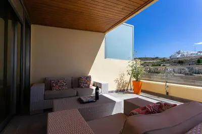 a living room with a couch and a large window at Big Terrace Apartment Cullera in Cullera